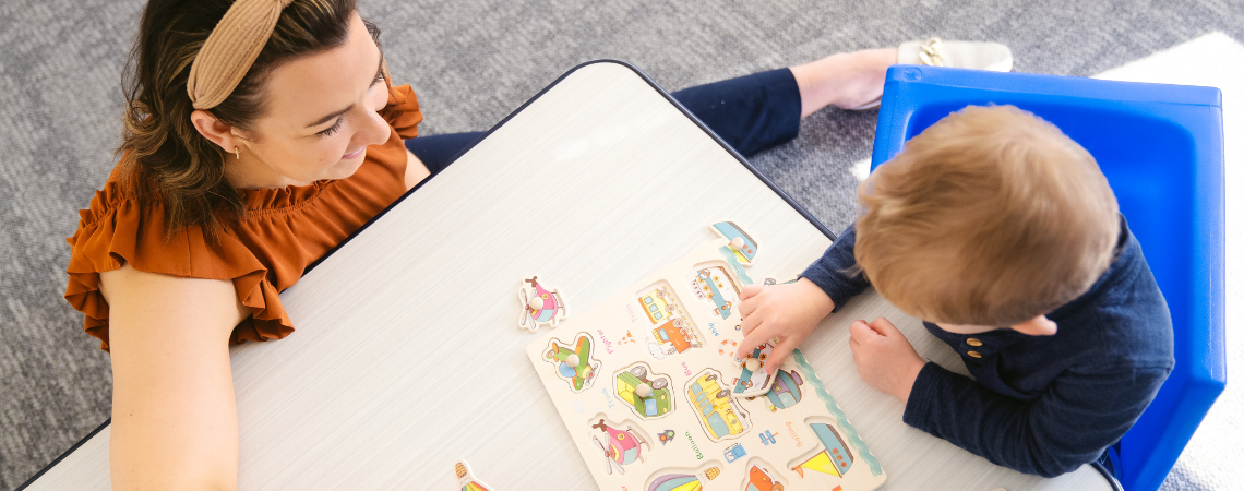 Child and adult playing with a puzzle
